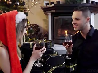 Beautiful young couple having sex by the fireplace on Christmas Day